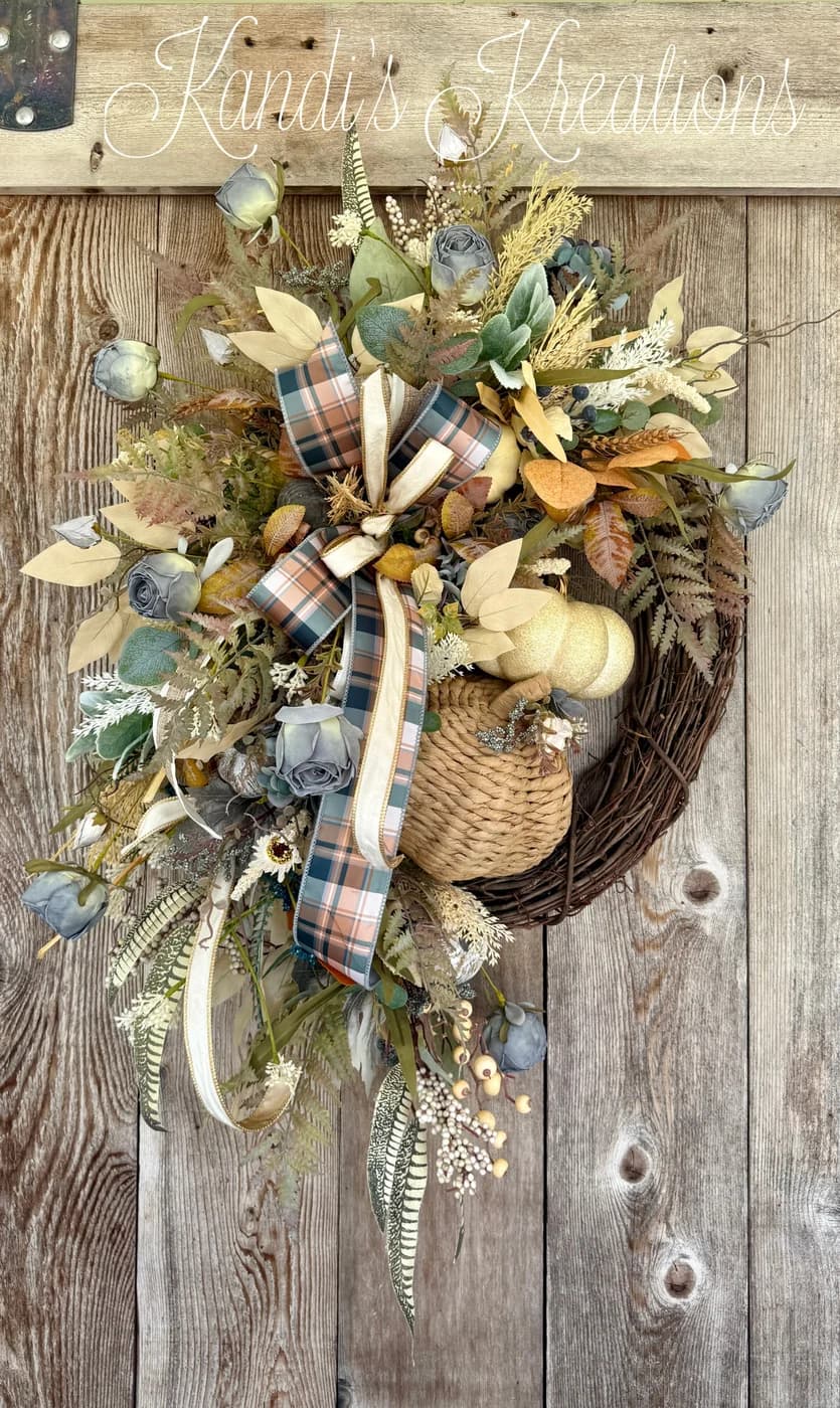 A neutral blue pumpkin fall wreath built on a natural grapevine base