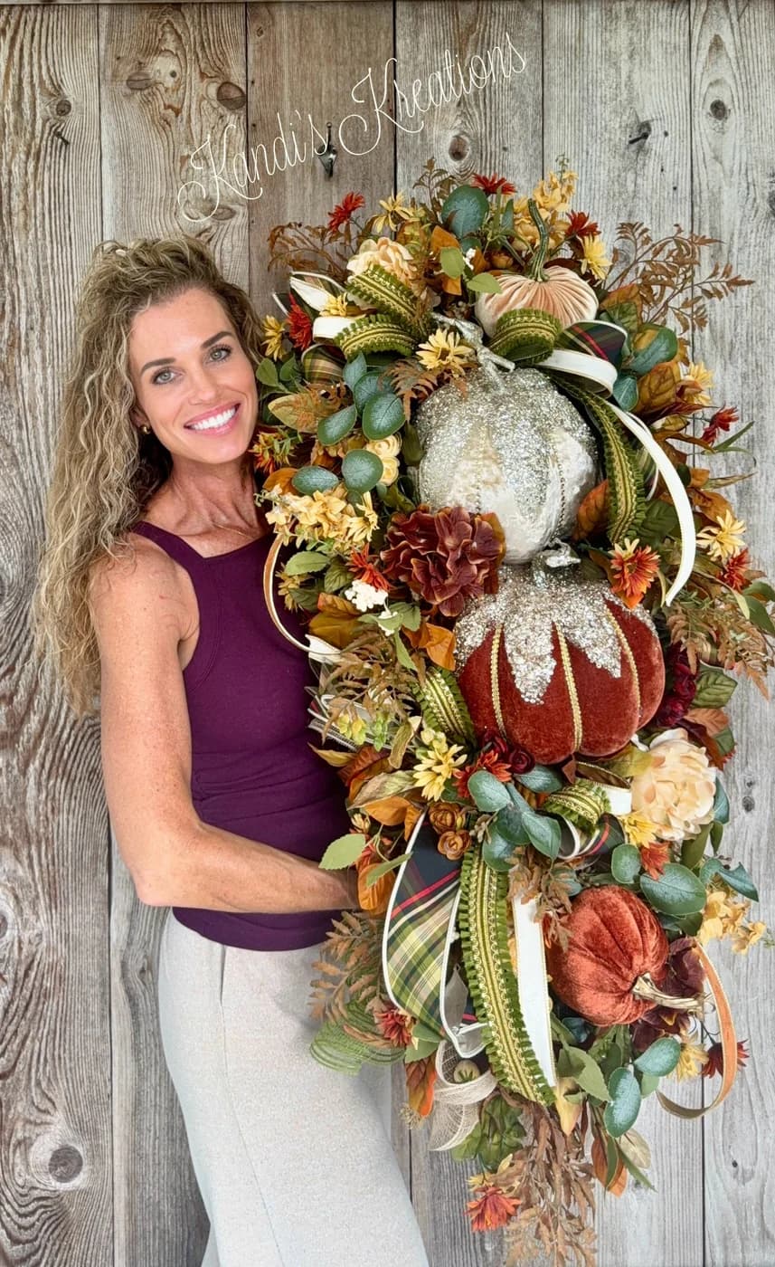 An oversized luxury fall pumpkin door swag hanging on a front door