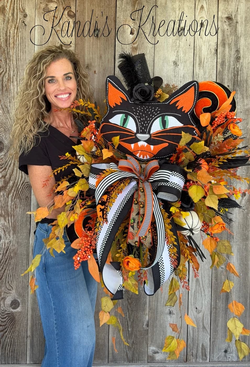A one-of-a-kind Halloween black cat wreath built around an oversized black cat centerpiece